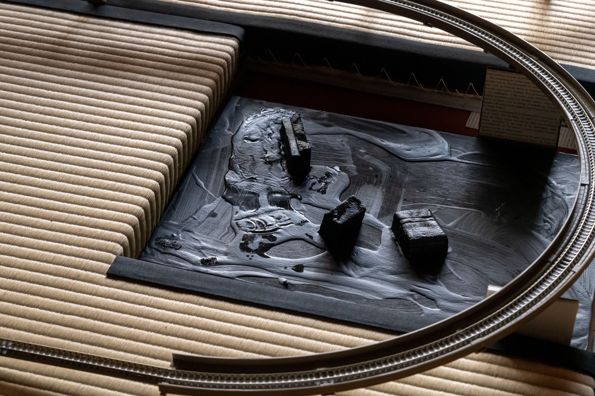 The track passes over the sunken hearth, filled with an oil-black landscape