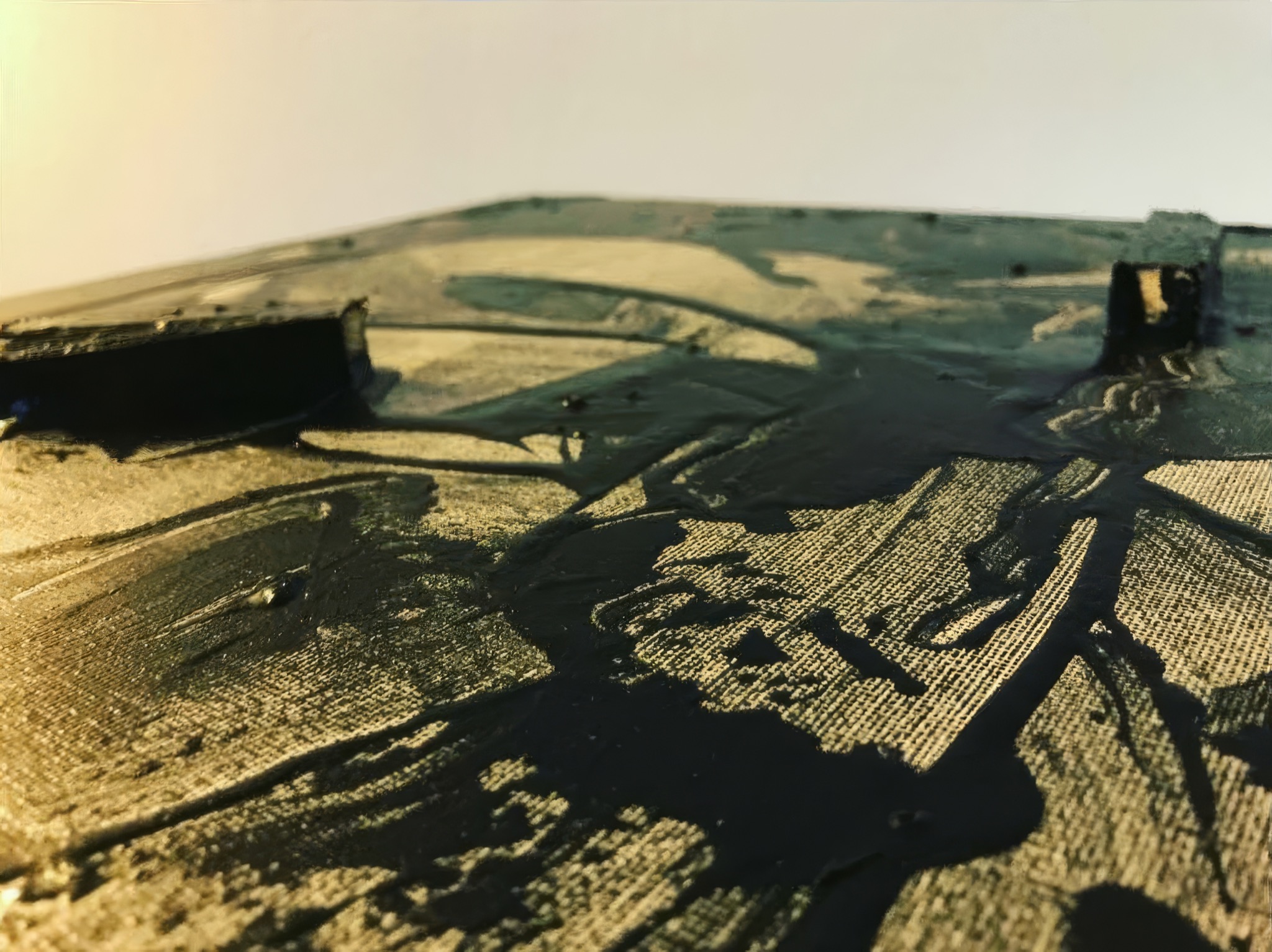 Detail of sweeping black marks and raised wood blocks