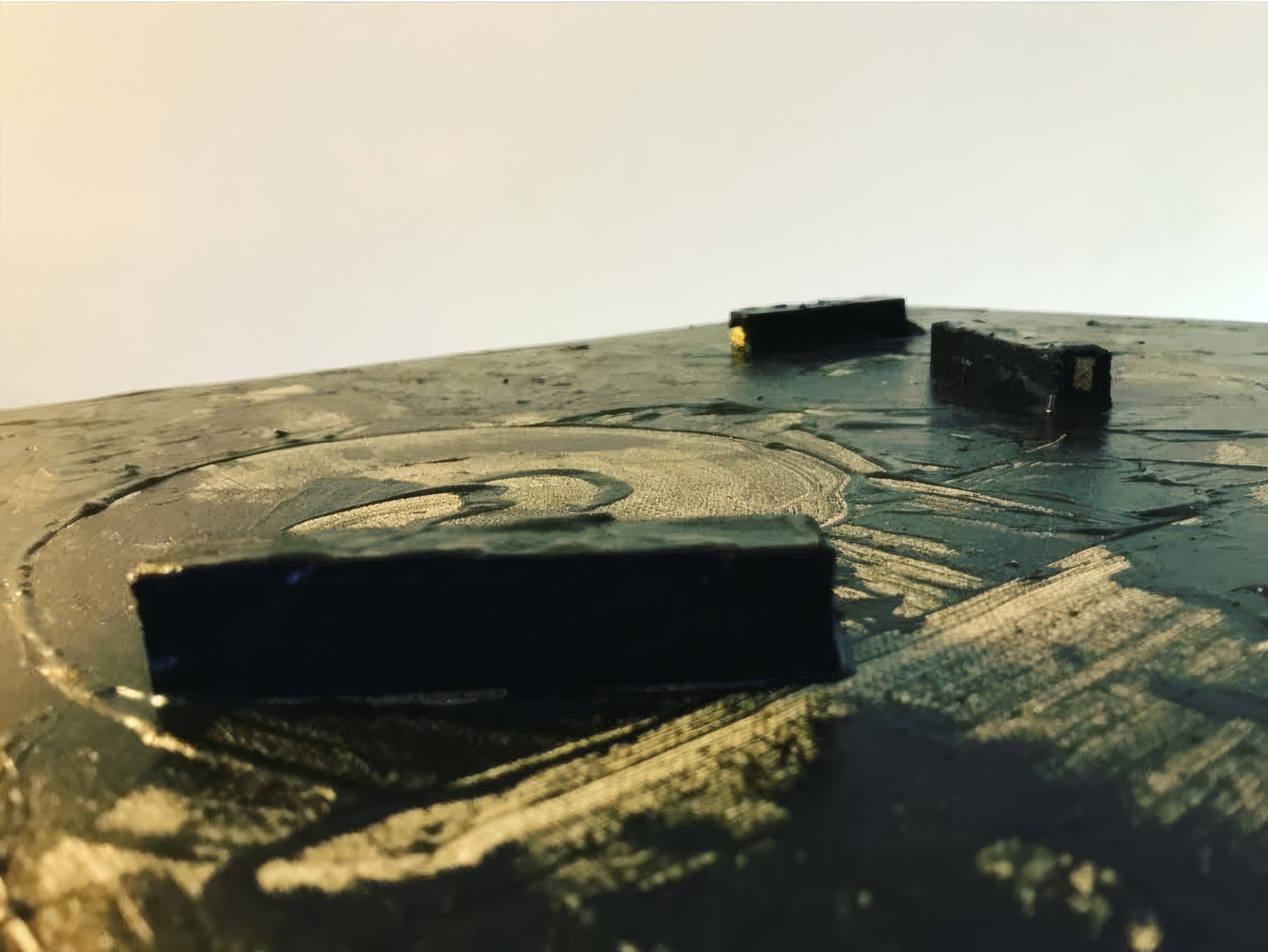 Wood blocks emerging from the dark painted surface