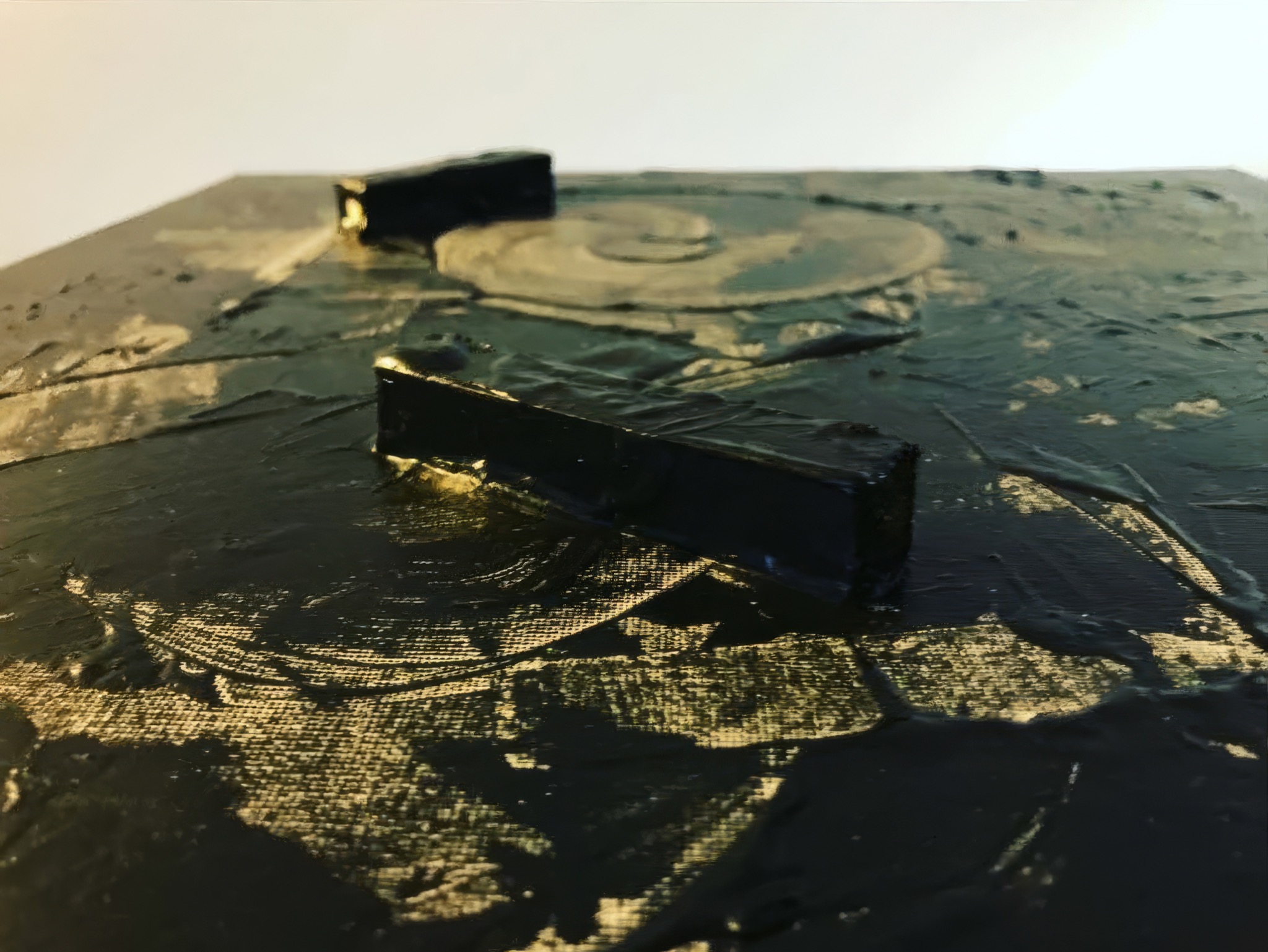 Light reflected across the textured surface of oil spill
